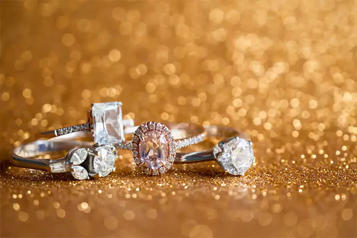 three diamond rings on a sparkling gold background